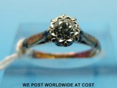 An 18ct gold ring set with a round brilliant cut diamond in an illusion setting (size J)