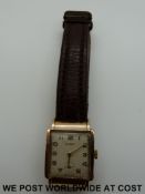 Garrard 9ct gold gentleman's wristwatch with subsidiary seconds dial on brown leather strap.