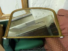A gilt framed over-mantel mirror with arched top,