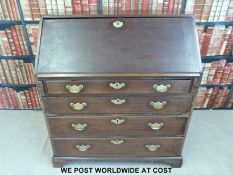 A Georgian mahogany bureau, the fall flap opening to reveal cubby holes,