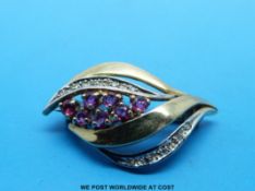 A 9ct gold brooch set with diamonds and rubies