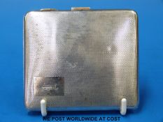 A hallmarked silver case with engine-turned design (weight 80g)
