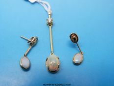 A yellow metal pendant marked 750 set with a round brilliant cut diamond with a drop section