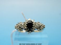 A 9ct gold ring set with an oval sapphire surrounded by diamonds (size M)