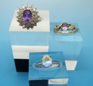 Two 9ct gold rings set with purple and clear stones and a yellow metal ring marked 14k set with a