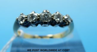 An 18ct gold ring set with five diamonds in a platinum setting (size P)