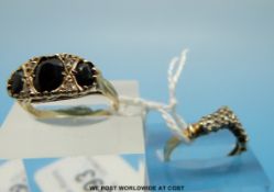 A 9ct gold ring set with garnets and another 9ct gold ring set with clear stones