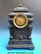 A single train timepiece in ornate cast iron case with floral and foliate decoration,
