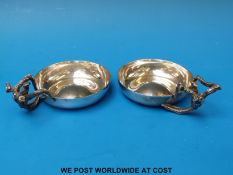 A pair of hallmarked silver tastevins with handles in the form of vines (Ldn) maker A G E for