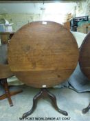 A 19thC oak tilt top table raised on a tripod base (H72 x diameter 77cm)