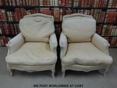 A pair of French style upholstered armchairs