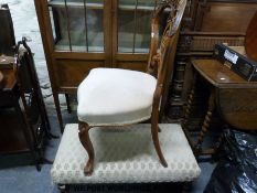 A carved decorated bedroom chair together with a long upholstered foot stool