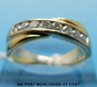 An 18ct gold ring set with eight diamonds in a cross over setting (size O/P)
