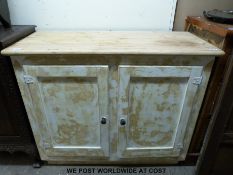 A pine two door cupboard with distressed painted finish to front (H86 x W107 x D46cm)