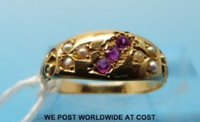 A 9ct gold ring set with three rubies and seed pearls (size K)