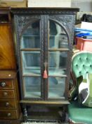 A 19thC glazed carved oak cabinet (H134 x W62 x D35cm)