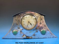 An early 20thC Arts & Crafts plated mantel clock with hammered,