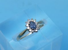 A 9ct gold ring set with a sapphire surrounded by diamonds (Size I/J)