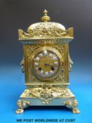 A French brass-cased mantel clock with Brevete Sonnerie movement, raised on lion paw feet,