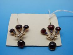 A pair of 15ct gold earrings set with garnets and seed pearls