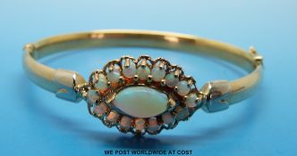 A 9ct gold bangle set with moonstone