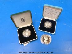 Two cased anniversary silver proof two pound coins together with a 32mm 50p piece sterling silver