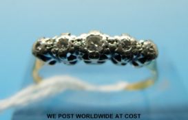 An 18ct gold ring set with five diamonds in an illusion setting (size L)