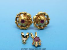 A pair of yellow metal earrings set with rubies and two pendants,