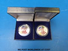 Two cased colourized USA eagle silver dollars, one for 1999,