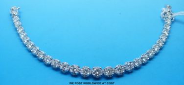 An 18ct white gold bracelet set with 27 round brilliant cut diamonds, total weight approximately 5.