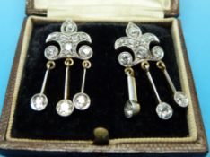 A pair of 18ct gold and platinum earrings of fleur de lys design set with old cut diamonds,