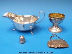 A hallmarked silver sauce boat raised on four paw feet (104g), white metal pedestal bowl,