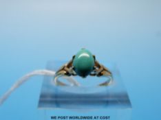 A 9ct gold ring set with an oval turquoise cabochon (size K)