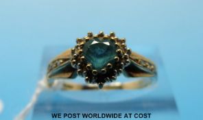 A 9ct gold ring set with a heart shaped aquamarine surrounded by diamonds (size O)