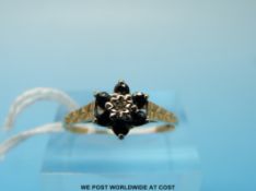A 9ct gold ring set with sapphires and a cubic zirconia in a cluster (size Q/R)