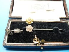Five yellow metal and other stick pins, one marked 15ct,