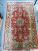A red ground rug (113 x 184cm)