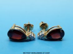 A pair of 9ct gold earrings set with garnets and diamonds