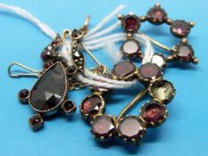 Two brooches set with garnets and an Edwardian pendant set with garnets