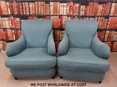 A pair of green armchairs.