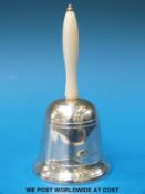 A hallmarked silver table bell with turned ivory handle, Ldn 1963,