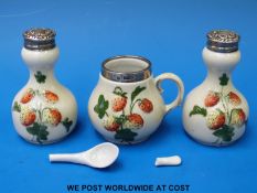 A three-piece relief moulded hallmarked silver mounted three piece cruet set