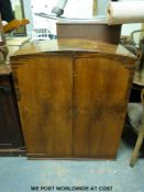 An Art Deco compactum with double doors opening to reveal shelves and drawers (height 110cm width