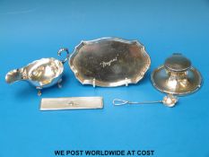 A hallmarked silver capstan inkwell, a white metal sauce boat (marked 800) 65g,