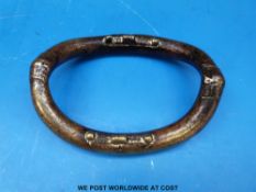 A brass tribal currency bangle