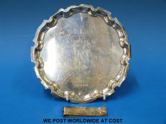 A hallmarked silver card tray (15cm diameter,