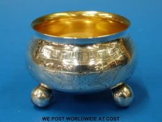 A Russian white metal open salt with gilt wash interior raised on ball feet (diameter 6.