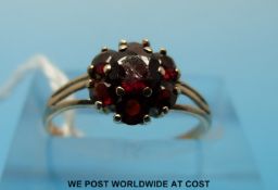A 9ct gold ring set with a cluster of garnets (size J/K)