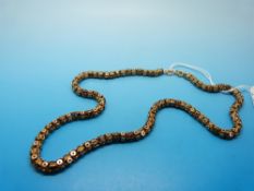 A yellow metal necklace of unusual links,