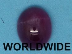 A ruby in an oval cabochon cut measuring 8.